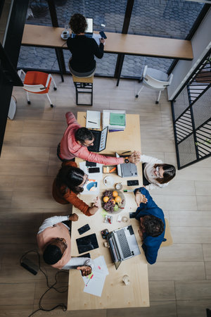 Above View of Business People Collaborating and Discussing Project Details for Successful Project Completionの写真素材