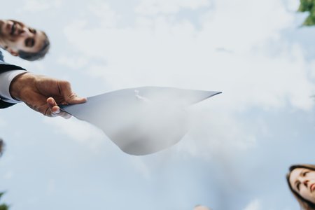 Graduates celebrate in the park wearing gowns, throwing the caps, congratulating each other and having fun after graduation. Last student life dayの写真素材