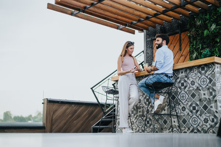 A business couple discussing growth strategy and new ideas at an urban cafe outdoors on a cloudy day.の写真素材