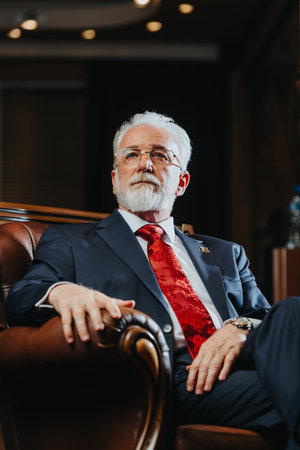 Experienced University Rector with Confident Posing In Modern University Officeの写真素材