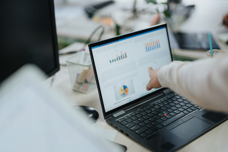 Multiracial Business Team Collaborating on Market Analysis and Strategic Planning in Corporate Office Settingの写真素材