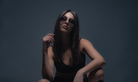 Posing and being playful with her hair while looking sexy with the sunglasses
