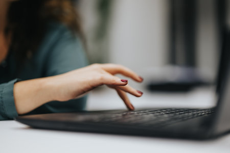 Close up shot of woman typing on lap top.の写真素材