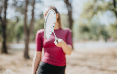 Sports girl posing with racket, showcasing her healthy lifestyle and gorgeous body shape.の写真素材