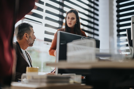 Different aged business team collaborating in a corporate office for successful project management and business growth.の写真素材