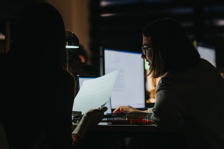 Collaborating Coworkers Discussing Business Growth and Analyzing Statisticsの写真素材