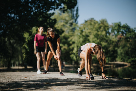 Fit Girls Enjoying Outdoor Sports Activities in a Sunny City Park.の写真素材