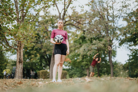 Sunny Day Training Outdoors - Fit Woman Enjoying Physical Activity in Natureの写真素材