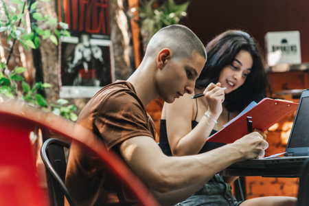 High School Students Discussing Different Topics and Relaxing at a Cafe After Classesの写真素材