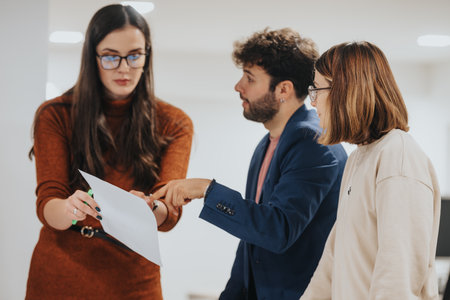 Multiracial Business Team Collaborating and Analyzing Reports for Financial Planning and Business Growthの写真素材