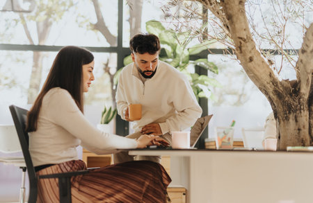 Multigenerational coworkers discuss project details, collaborate in office for business growth and profitability.の写真素材