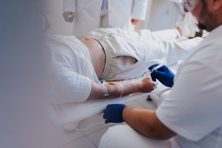 In a hospital room, a patient receives infusion therapy from a doctor, ensuring proper care and treatment.の写真素材