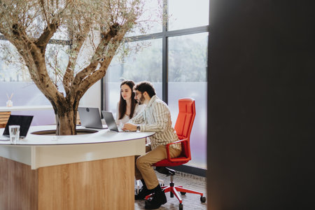 Multiethnic coworkers discussing project details and collaborating on business expansion in a...