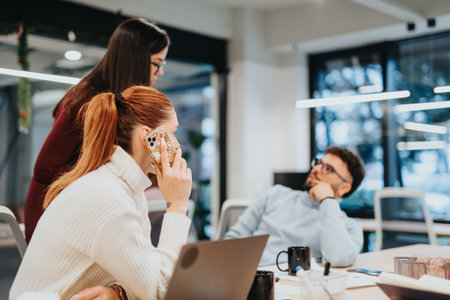 Focused colleagues discussing business expansion strategy in a pleasant office atmosphere.の写真素材