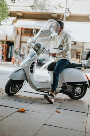 Middle-Aged Businessman Leaving on a Motorbike After Work, Ready to Leave His Workspace.の写真素材