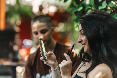 High School Students Studying and Discussing Different Topics Together After Classes in a Cozy Cafeの写真素材