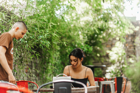 High school students studying and enjoying their free time together at a cafe after classes.