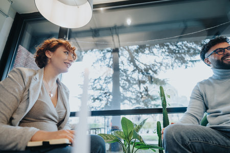 Confident coworkers discussing financial reports in creative office.