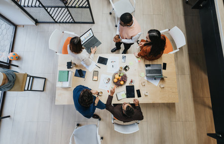 A group of colleagues from different generations discussing business solutions in a creative office.