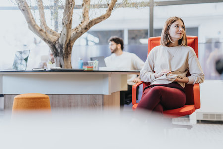 Multiethnic colleagues collaborating and discussing ideas in a corporate office.の写真素材
