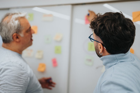 Colleagues collaborate in a corporate office, brainstorming and strategizing for business expansion and success.の写真素材