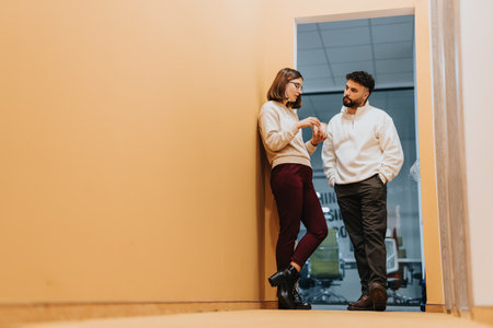 Male employee flirting with his colleague at work.の写真素材