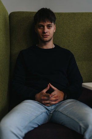 Young male employee enjoying a break from work and posing for the camera.