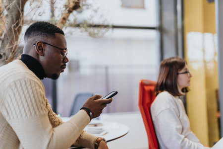 Man scrolling on phone at work. Searching information.の写真素材