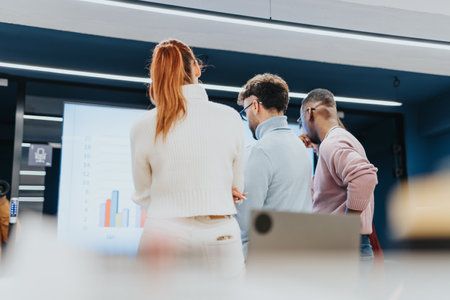 Collaborative brainstorming session with successful young entrepreneurs discussing market analysis and strategizing for business expansion.の写真素材