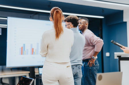 Business professionals collaborate in an office, brainstorming, discussing statistics, and strategizing for market analysis and profit growth.の写真素材