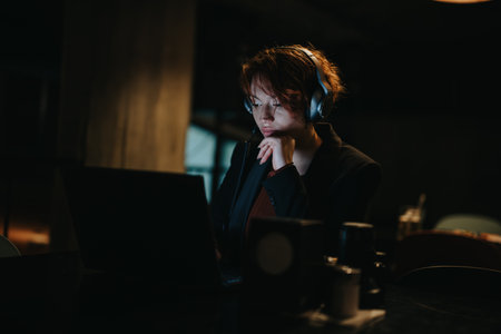 Successful businesswoman analyzing data for profit growth in late night office meeting.の写真素材