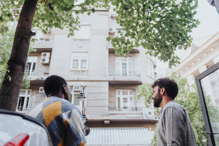 A multiracial team of professionals collaborate outdoors, discuss ideas, and develop innovative...