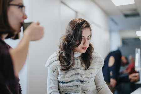 Businesspeople discussing project strategy in a modern office kitchen.の写真素材