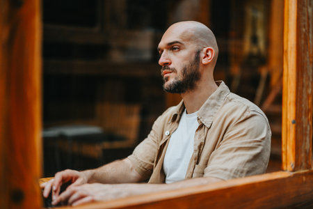 Multicultural Start-up Team Expands Business Plan with Creative Growth Hacking Strategies in Urban Coffee Bar Meetingの写真素材