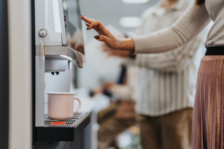Cropped photo of woman making a coffee using a coffee machine.の写真素材