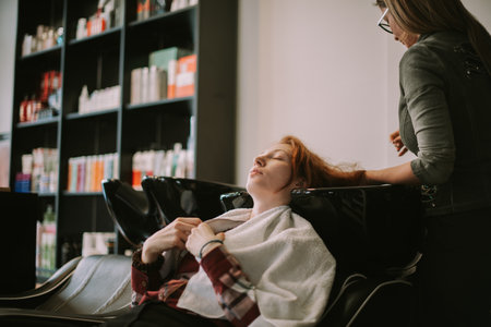 Hairdresser getting ready to wash hairの写真素材