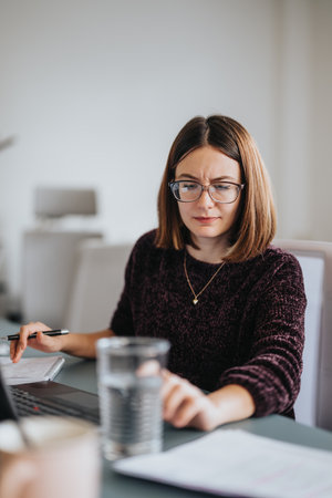 Business female person working and discussing ideas in a creative office.