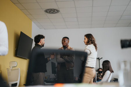 Multigenerational team collaborating in a creative office for discussing digital marketing strategy.の写真素材