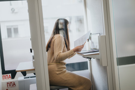 Successful businesswoman analyzing statistics and discussing possible solutions in a meeting call.