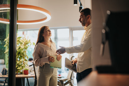 Multiracial start-up team in a modern co-work space. Analyzing market data, discussing business strategies and networking for the stock market.の写真素材