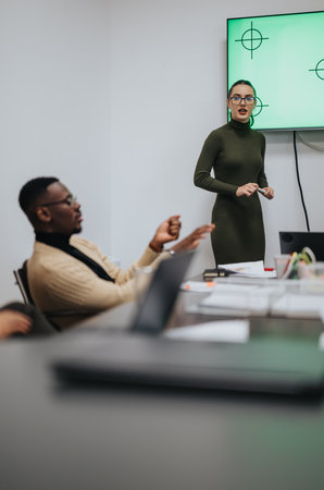 Multiracial colleagues collaborating and discussing ideas for business growth in the eveningの写真素材