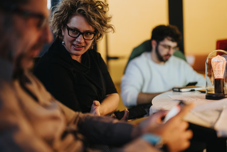 Group of colleagues discussing business strategy in an evening meeting.