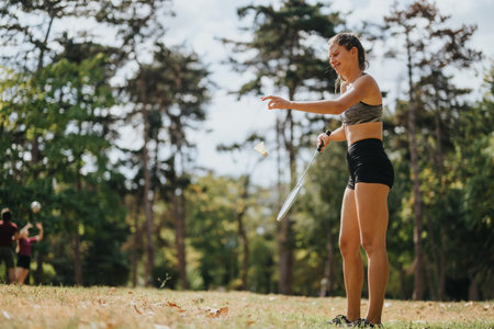 Attractive Athlete Enjoying a Game of Badminton in a Park. Copy Space.の写真素材