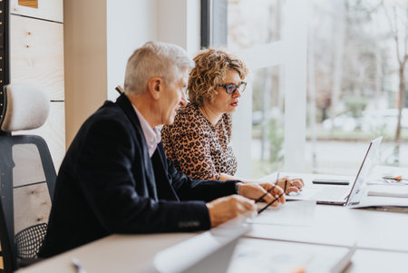 Team of professionals working in a modern office. Happy and successful group working together on...