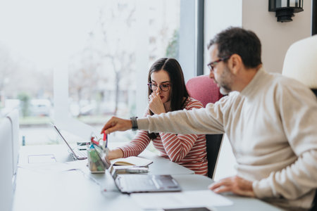 Cross generational business coworkers discussing market analysis and revenue growth.の写真素材