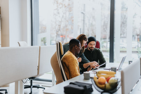 Successful professionals collaborating on a creative business project in a diverse and innovative office.の写真素材