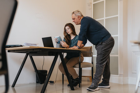 Multi generational team of workers collaborating in innovative office environment.の写真素材