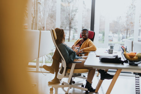 A diverse team collaborating on a project in an innovative office, discussing business strategies and working together towards success.の写真素材