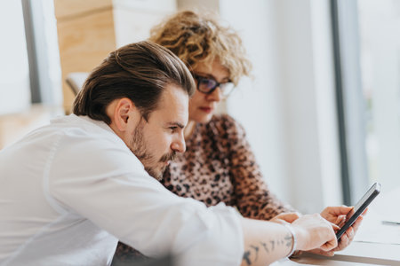 Successful teamwork: Multicultural businesspeople discussing and sharing ideas in the office.の写真素材