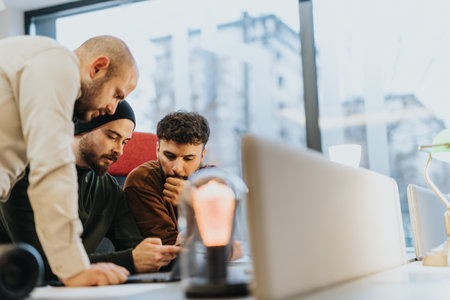 Team of confident businesspeople collaborating in an innovative office environment, working towards...